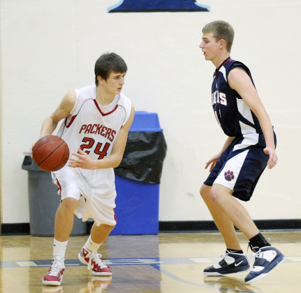 ustin's Tom Aase (24) is defended by Albert Lea's Aaron Klatt Tuesday during the second half at Albert Lea High School. Austin ended the first half on a 26-2 run en route to a 66-41 win. -- Andrew Drydal/Albert Lea Tribune