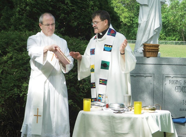 Deacon John Kluszny (left) and Father Joseph Fogal lead last year’s Memorial Day Mass at Calvary Cemetery in Austin. — Provided by Julie Bjorge