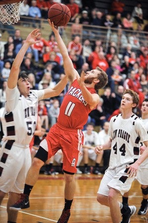 Austin’s Tommy Olmsted charges in for a layup against New Prague in the first earlier this season in Packer Gym.