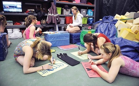 Members of the Austin Packers gymnastics team make posters for their hotel rooms this weekend when they take part in the Minnesota State Gymnastics Meet Friday and Saturday. Look for a in depth preview of this weekend's meet on page 10.