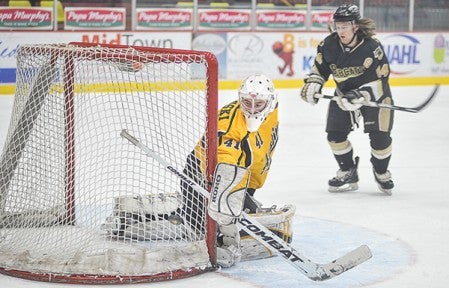 Austin Bruins goalie Jason Pawloski deflects a shot Friday night against Bismarck in the first period at Riverside Arena.