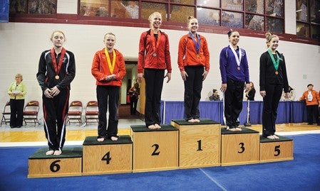 Austin's Sela Fadness stands atop the podium after she was named Class A state champion in the all around Saturday at the Minnesota State Gymnastics Meet at the University of Minnesota's Sports Pavilion. Teammate Maddie Mullenbach finished fourth in the all around.