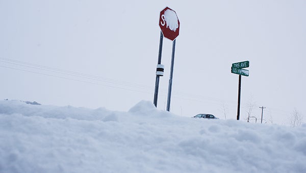 State and county highways were difficult to navigate Friday morning in southeastern Minnesota. Here, snow is piled high where a side road meets Highway 63. -- Matt Peterson/matt.peterson@austindailyherald.com