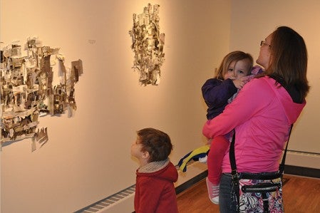 Same Reimers, right, looks at some of Matthew Winkler's art with her children, 4-year-old Mason and 2-year-old Emma, at the "Site Drawings" exhibit inside Riverland Community College's James Wegner Art Gallery.