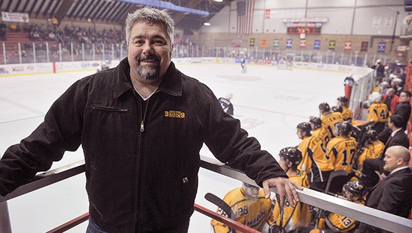 Craig Patrick, owner of the Austin Bruins, stands near the Bruins bench during a January game against Coulee Region. In its third year, the organization has grown and surged in the NAHL with an average fan draw of over 1,000 people and one of the top records in the NAHL. -- Eric Johnson/Austin Daily Herald