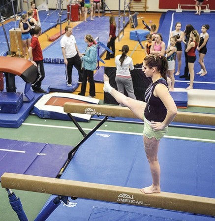 Austin's Cassidy Bawek spends some time on the balance beam during a January practice at the YMCA.