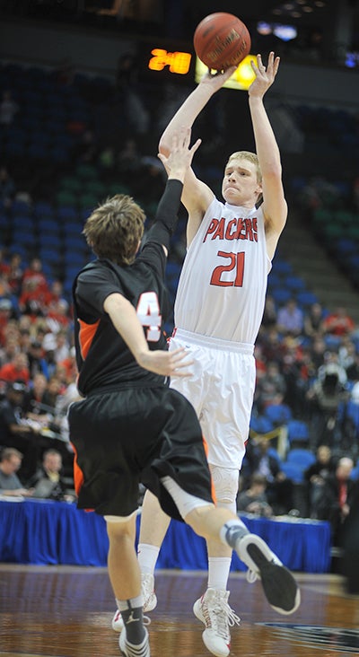 Joe Aase shoots over a Marshall defender in the first half Thursday in the Class AAA state tournament semifinal.