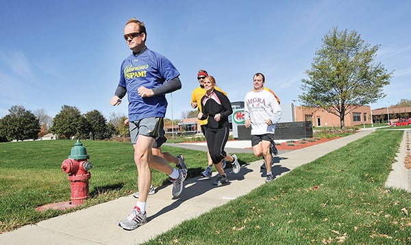 A group of runners including Jeff Grev, Greg Basking, Brent Brehmer, Nicole Shute, Tim Garry and Scott Nemec head out from Hormel Corporate North for their daily run.