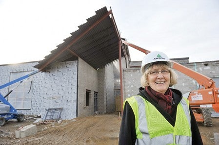 Jean McDermott stands outside what will be the main entrance to the I.J. Holton Intermediate School. McDermott is spearheading the building effort and will be principal when the project is complete.