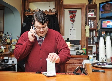 Justin Brandau takes a sandwich order at Sweets Hotel Restaurant & Lounge in LeRoy.