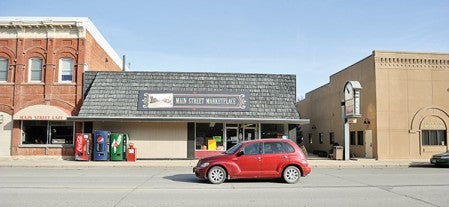 A car sweeps past the Main Street Marketplace in LeRoy. While a lot of Main Streets in small towns are drying up, LeRoy still boasts a relatively busy main thoroughfare.