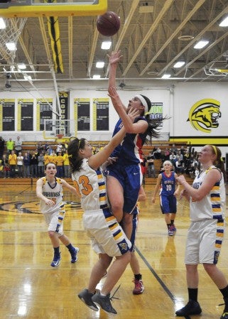 Southland's McKenzie Kirtz shoots a lay-up over Hayfield's Grace Walker in a Section 2AA South tournament game in Mankato East High School Friday. -- Rocky Hulne/sports@austindailyherald.com