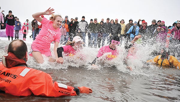 The first group hits the water during the Plunging for Pink in February, part of Paint the Town Pink. The event was sponsored by the Waterways committee. Herald file photo