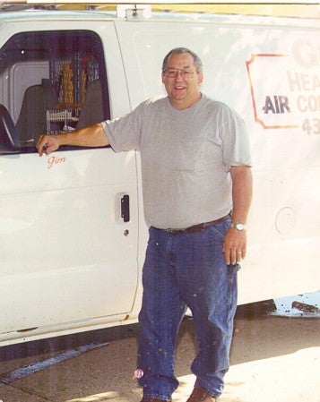 Jim Grunewald, who retired in January from G&G Heating and Air Conditioning, stands beside a company truck. Photo provided