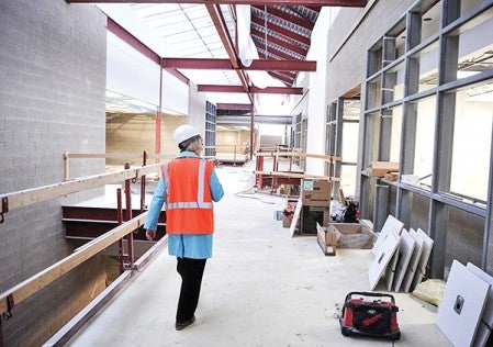 Jean McDermott walks through the site of the new school.