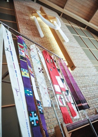 Stoles hang beneath the cross over the alter at First Congregational Church, part of the exhibit Shower of Stoles, that shows support those in the GLBT community of faith. The exhibit begins today and runs through May 15.