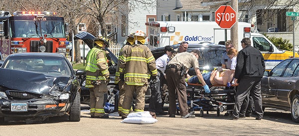 The driver of one vehicle involved in a two-car accident Tuesday morning is loaded onto a gurney before being taken to Mayo Clinic System Health in Austin. The accident occurred before noon at the intersection of First Avenue and Sixth Street Northwest. -- Eric Johnson/photodesk@austindailyherald.com