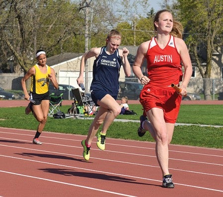 Austin's AnnaLena Kehm leads her leg of the 4x200 relay in a triangular with Mankato East and Rochester Century.