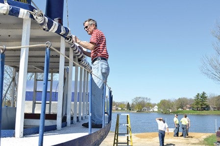 Dick Nordin, one of the pilots for the Spamtown Belle, does some prepwork before the boat is launched on East Side Lake Tuesday morning for the 2013 season.