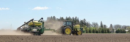 Brian Hanson plants a field south of Grand Meadow Thursday afternoon as farmers throughout the area hit the fields to take advantage of the nice weather.