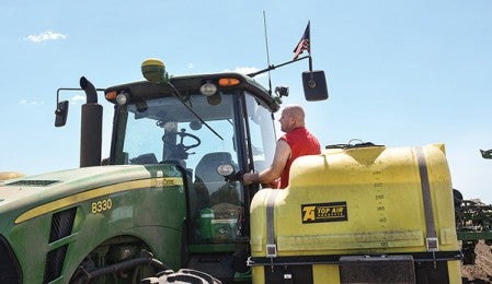 Brian Hanson gets back in his tractor to finish planting a field of corn south of Grand Meadow Thursday afternoon.