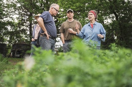 Rep. Tim Walz talks with Jon Jovaag and his mother Lois about their farm operation Thursday.