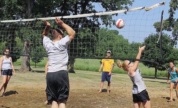 Adam Krause goes up for a block during the volleyball tournament at the Rose Creek park during Fun Days.  Herald file photo