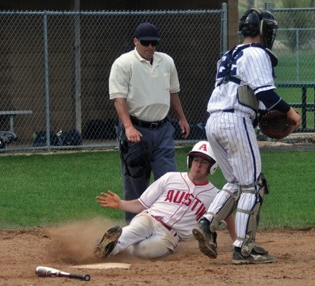 Austin's Ethan Horstmann slides into home plate during the second game of a doubleheader against Rochester Century in Dick Seltz Field Saturday. -- Rocky Hulne/sports@austindailyherald.com