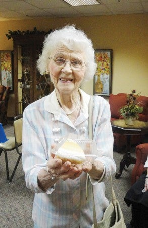 The Cedars of Austin resident Lorraine Bartz holds up a slice of pie as part of a bake sale fundraiser for the victims of the Moore, Okla. tornado earlier this year. Photo provided