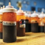 Bottles of barbque sauce, including the Jackass Sauce, sit on a table at Piggy Blues Thursday morning as the popular restaurant perpares to open for the day. The Jackass Sauce recently won a state-wide competition at Treasure Island that included a $300 prize.