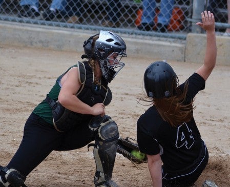 Blooming Prairie's Abby Wayne tries to slide past New Life Academy catcher Malorie Giere in the sixth inning of BPs 3-1 win in the Class 'A' state title game. Wayne was called out on the play. -- Rocky Hulne/sports@austindailyherald.com