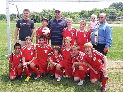The Austin U1 boys soccer team is headed to the C3 state youth soccer tournament. Back row: (left to right): coach Corey Goetz, Joel Vargas-Soto, coach Tim Dolan Peterson, Toby Gogolewski, William Kahle, and coach Lucas Mangels, with daughter Finlee; front row: Isaiah Chhin, Dylan Hanegraaf, Hector Morales Keaton Goetz, Rafe Dolan-Peterson, Ethan Mangels and Elisha Simerson. -- Photo Provided