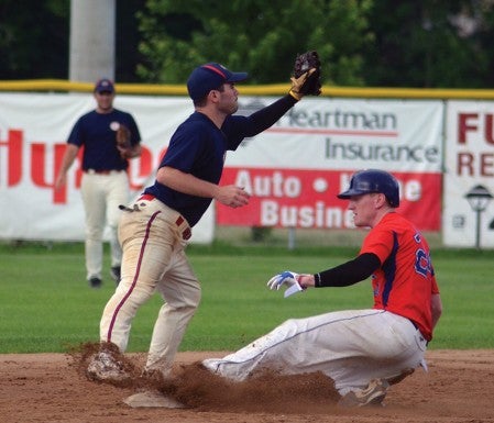 Chris May of the Austin Blue Sox slides into second base as Hayfield's Shane Barry pulls in a throw in Marcusen Park Monday. -- Rocky Hulne/sports@austindailyherald.com