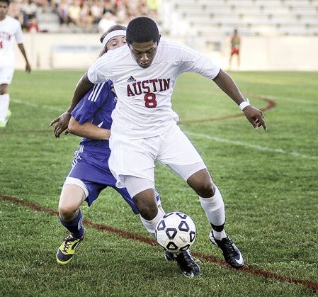 Austin's Carlos Vera fends off Waseca's Alex Roesler during the first half Thursday night at Art Hass Field.