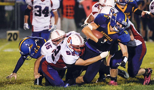 Hayfield's Merrick Ducharme is brought down by Southland's Brady Reuter on a run in the third quarter Friday night in Hayfield. -- Eric Johnson/photodesk@austindailyherald.com