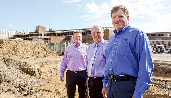 From left, Nate Jansen, Kelly Wadding, and Dale Hicks of Quality Pork Processors, Inc., stand in front of what will soon become a new clinic for QPP employees and their families. The primary care clinic will open in mid-October. Trey Mewes/trey.mewes@austindailyherald.com