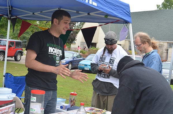 Minnesota NORML Board Chairman Brandan Borgos, left, talks to people about the potential benefits of the hemp industry during the first annual Austin Minnesota Hemp Fest Sunday. Minnesota NORML was the main sponsor behind the event, according to organizer Deanna Rider. Trey Mewes/trey.mewes@austindailyherald.com