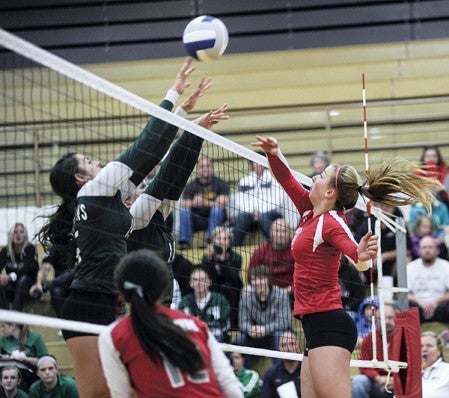 Austin's Shayley Vesel tips over a block in game one the Packers' match against Faribault Tuesday night in Packer Gym. Eric Johnson/photodesk@austindailyherald.com