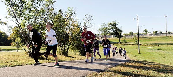 Runners taking part in the annual Austin Police Officers Association 5K Run/Walk Saturday run through Todd Park. Funds are used to support youth and civic activities and education throughout Mower County. A portion of the proceeds will go to the Austin High School cross country team for helping with the event. Look for results in Monday’s sports section of the Austin Daily Herald.  Eric Johnson/photodesk@austindailyherald.com
