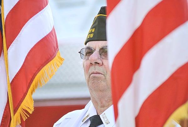 Clayton Oehler of the Austin VFW No. 1216 color guard, stands at attention during the Patriot’s Day remembrance last year at the Veteran’s Memorial. -- Herald file photos