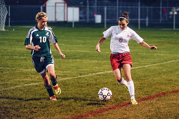 Austin's Rebecca Poss dribbles up the sidelines while being shadowed by Faribault's Payton Putrah during the first half Tuesday night Art Hass Stadium. Eric Johnson/photodesk@austindailyherald.com