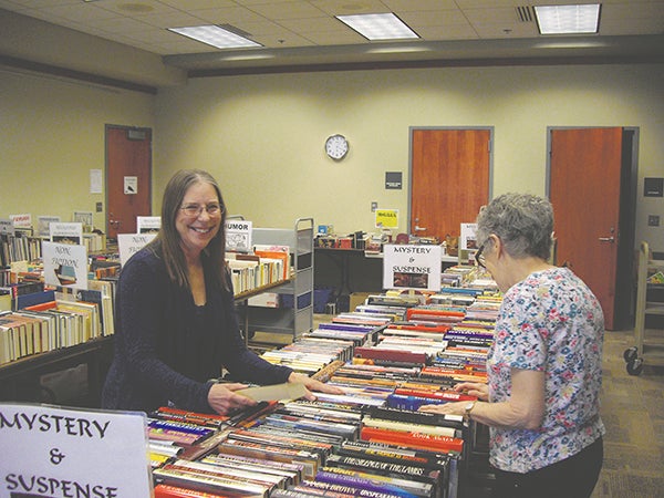 Nancy Bakke-McGonigle and Bev Smith sort books for this week’s used book sale at the Austin Public Library.  Photo provided