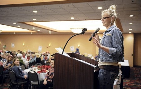 Special guest speaker Taryn Emery, last year's recipient of a Riverland Community College scholarship for non-traditional female students, talks about the experience during the annual Ladies Night Out Thursday night at the Holiday Inn Convention Center. Eric Johnson/photodesk@austindailyherald.com
