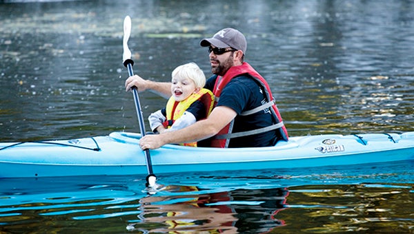 Ernie Hammero and his son, Carson, paddle Sept. 30 on the Cedar River at the Ramsey Dam as part of Austin Community Education's "Dad, Grandpa & Me" class. Cedar River Watershed District led the waterways event. Nate Howard Photography