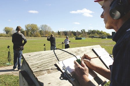 AHS trapshooting team manager Paul Jenkins keeps score during the 16-yard trap round on Saturday.