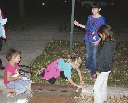 Girl Scouts from Austin helped with the storm sewer awareness project on Oct. 10 as part of Community Cleanup for Water Quality. --Photo provided