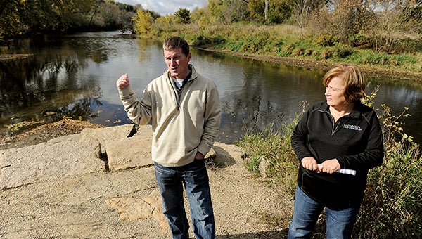Justin Hanson, resource specialist for the CRWD, and Bev Nordby, administrator for the CRWD, stand at the point where Dobbins Creek and the Cedar River meet in Driesner Park. Work at this point could reduce flooding by 8 percent. -- Eric Johnson/photodesk@austindailyherald.com
