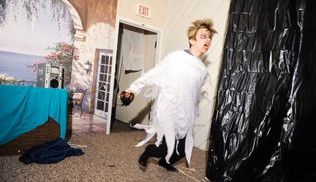Ethan Larson jumps out at some visitors to the Frightmare Manor haunted house. 