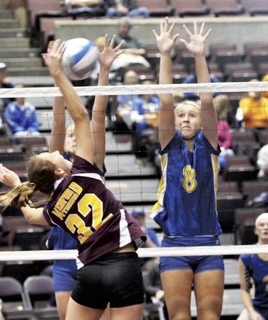 Hayfield's Katelyn Bjornson, right, goes up to block a hit by Medford's Hannah Robb in Mayo Civic Center Saturday. -- Rocky Hulne/sports@austindailyherald.com