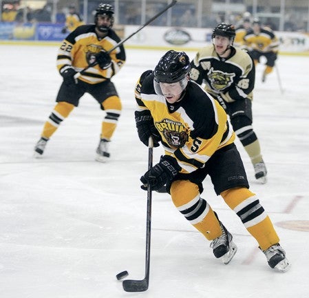 The Austin Bruins' Josh Bretner controls the puck in the Bruins' zone during the first period Friday night against Bismarck, N.D. at Riverside Arena. Eric Johnson/photodesk@austindailyherald.com.
